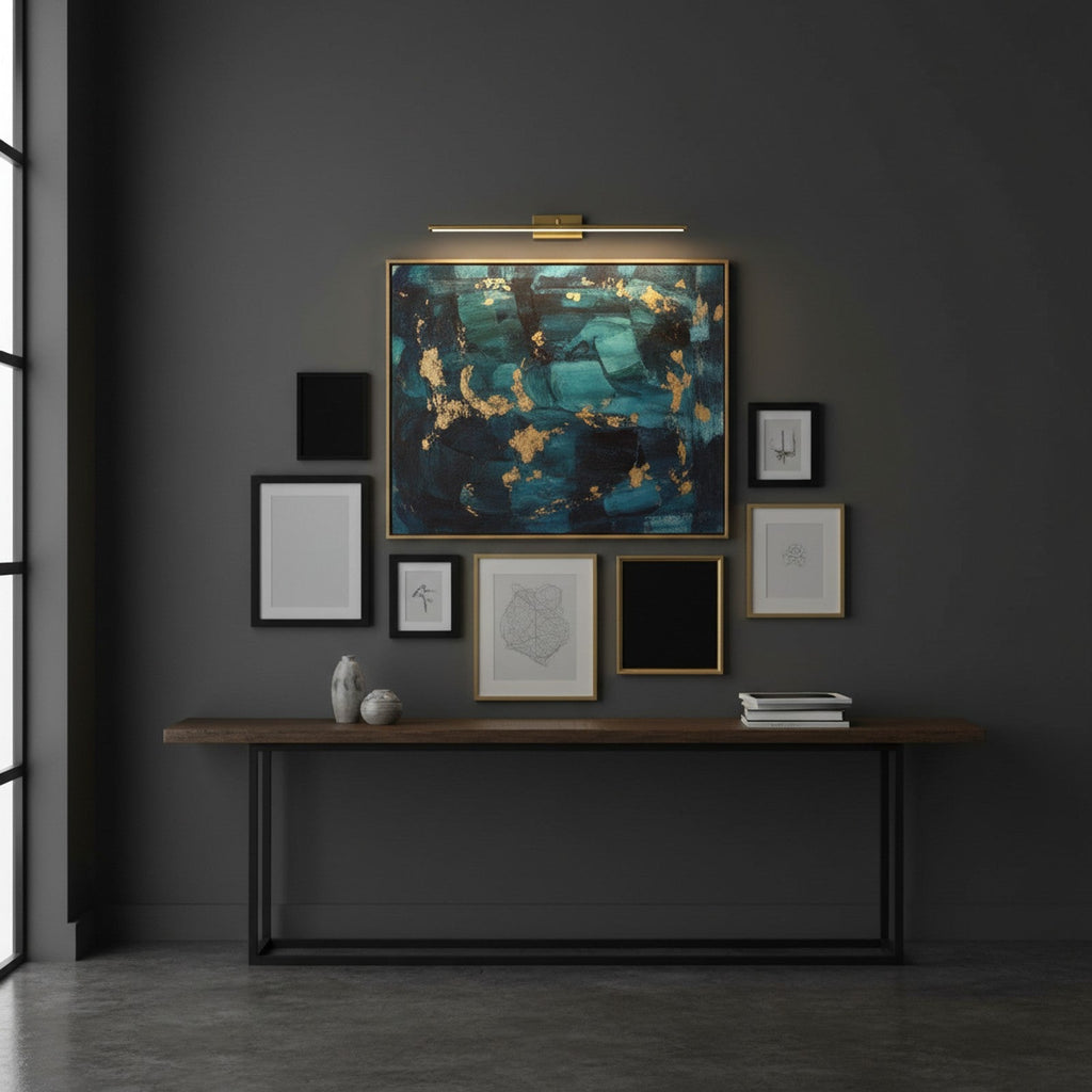 Brass LED linear light as picture light above artwork on dark gallery wall